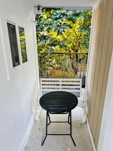 a bench sitting on a porch with a table at 1 Bedroom Mini Apartment 10 Minutes to SeaTac Airport 1 Minute Walk to Bus Station in Seattle