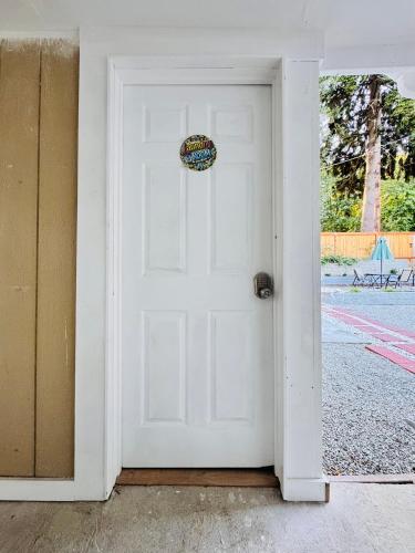 a white door with a sign on top of it at 1 Bedroom Mini Apartment 10 Minutes to SeaTac Airport 1 Minute Walk to Bus Station in Seattle