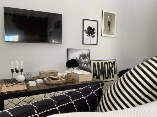 a living room with a couch and a table at Bellamore - Stylish Loft Studio with Sea Views in Brenton-on-Sea