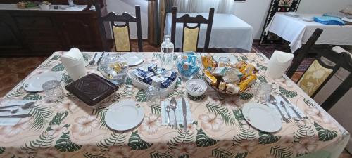 a table topped with plates and silverware on a table at Il giardino del Sole in Florinas