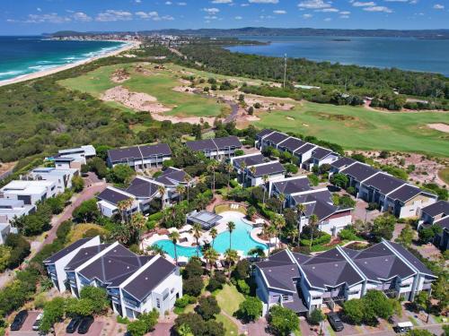 an aerial view of a resort with a pool at Pullman Magenta Shores Resort in The Entrance
