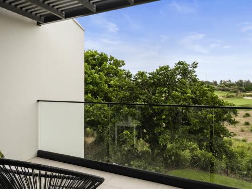 a view from the balcony of a house at Pullman Magenta Shores Resort in The Entrance