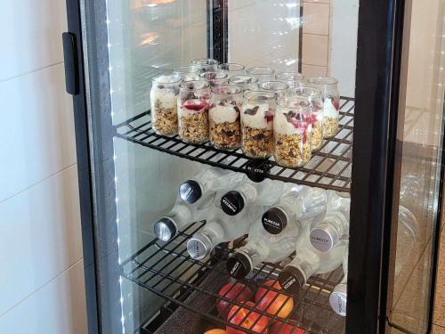 a refrigerator filled with lots of drinks and food at Pullman Magenta Shores Resort in The Entrance