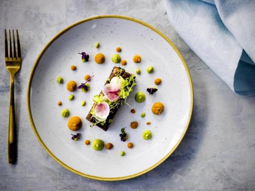 a white plate with a piece of food on it at Pullman Magenta Shores Resort in The Entrance