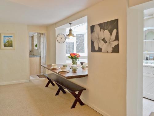 a dining room with a table and a bench at Midships in Instow