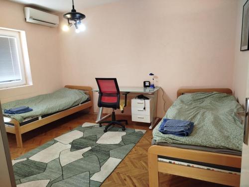 a room with a desk and a bed and a chair at Apartment "Daisy Flower" - Center, Bitola in Bitola