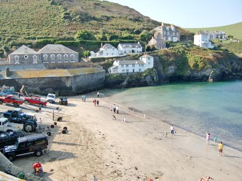 a group of people on a beach near the water at Lower Moon in Port Isaac