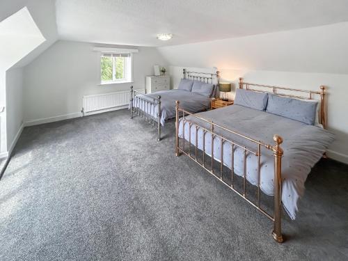 a bedroom with two beds and a window at Church View in Hunstanton
