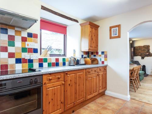 a kitchen with wooden cabinets and a stove at Judd in Launceston