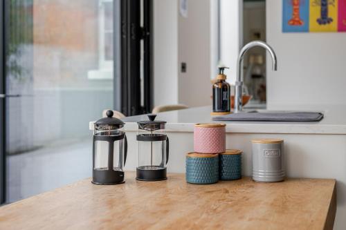 a kitchen counter with several appliances on a wooden table at Stunning Townhouse & Basement in Leamington Spa in Leamington Spa