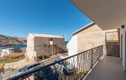 a balcony with a view of a building and a car at Amazing Apartment In Metajna With Wifi in Metajna