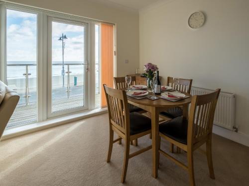 a dining room with a table and chairs and a window at Culver View in Shanklin