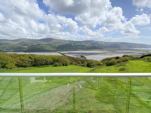 two views of a river from a glass window at Cae-Fadog Fach in Barmouth