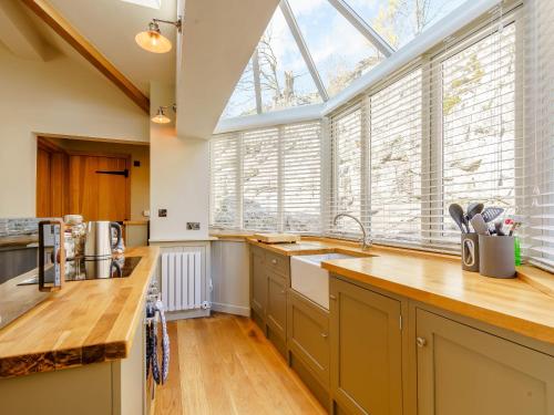 a kitchen with a large window and a sink at Limecroft in Malham