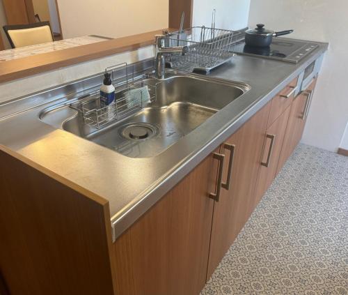 a stainless steel kitchen sink in a kitchen at Otsu guest house3 in Chikusei