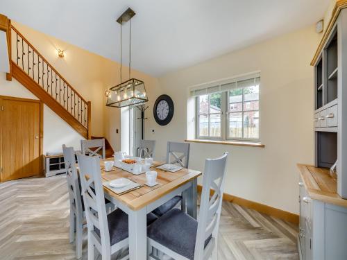 a kitchen and dining room with a table and chairs at Garth House - Castlesteads in Brampton