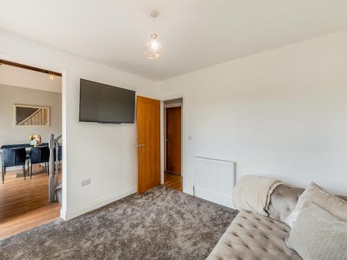 a living room with a couch and a flat screen tv at Vallum Villa - Uk40231 in Bardon Mill