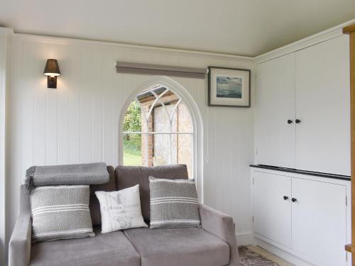 a living room with a couch and a window at The Little Cottage in Fittleworth