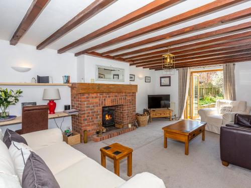 a living room with a fireplace and a couch at Box Tree Cottage in Pickering