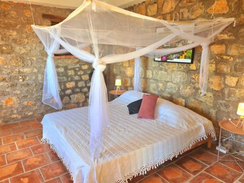 a bedroom with a bed with a mosquito net at Provence villa with heated pool and amazing view in Montauroux
