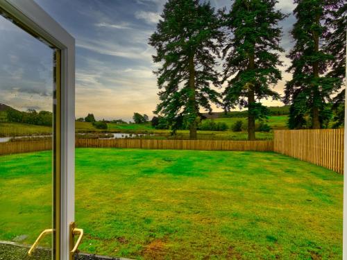 a window view of a yard with a fence at Easter Caiplich - Uk30263 in Cray