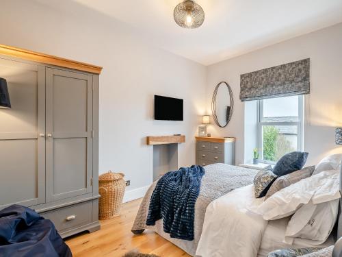 a bedroom with a bed and a television in it at Number Seven in High Bentham