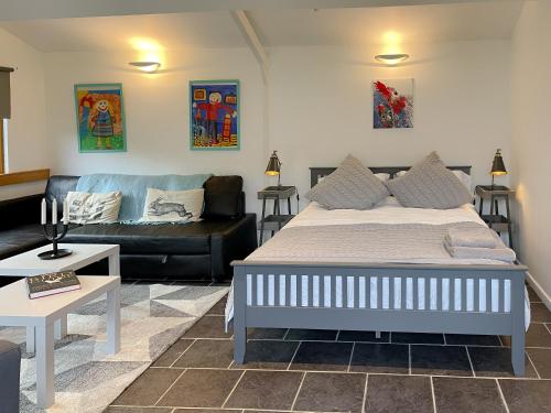 a living room with a bed and a couch at The Lodge At The Lake House in Plaistow