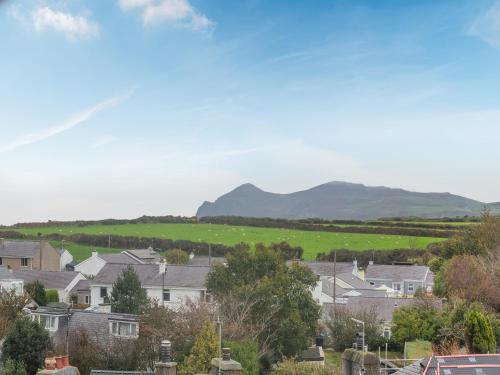 a town with houses and mountains in the background at The Penthouse in Morfa Nefyn