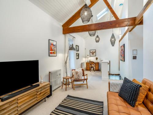 a living room with a large flat screen tv at The B Hive At Buckstone House in Carnforth