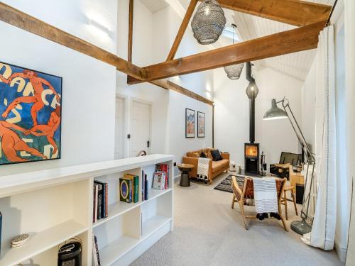 a living room with white walls and wooden beams at The B Hive At Buckstone House in Carnforth
