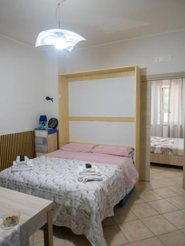 a bedroom with a large bed and a table at Il Paradiso Verde in Pagani