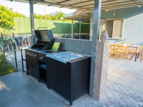 an outdoor kitchen with a stove and a patio at Il Paradiso Verde in Pagani