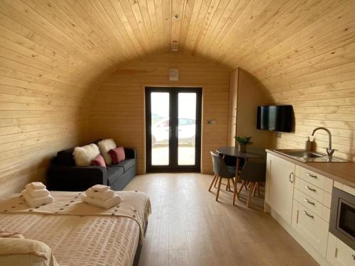 a room with a bed and a table and a kitchen at Foty - Uk2781 in Llanelidan