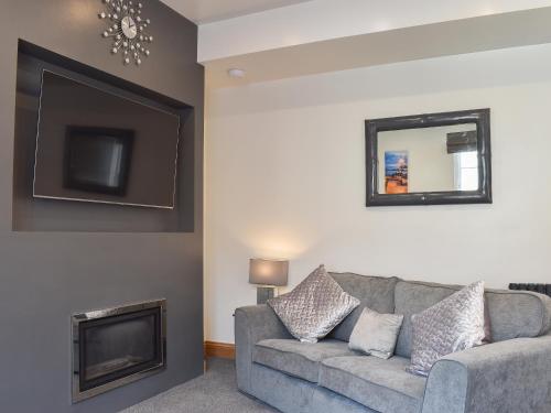 a living room with a couch and a tv at George's View in Whitby