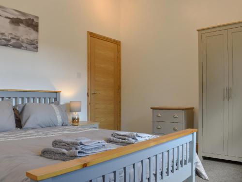 a bedroom with a bed with towels on it at George's View in Whitby