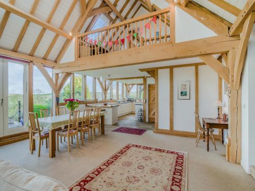a kitchen and dining room with a wooden ceiling at Wylye Croft in Upwey