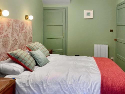 a bedroom with a white bed with two pillows at Alt Na Blathaich in Coirantee