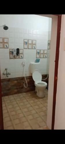 a bathroom with a toilet and a bath tub at CHIC yellow 2bhk- Just 10 Mins to Beach and WhiteTown DAWN in Puducherry