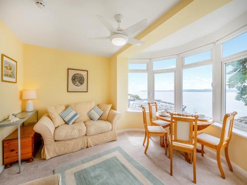 a living room with a couch and a table at Boohay - Bay Fort in Torquay