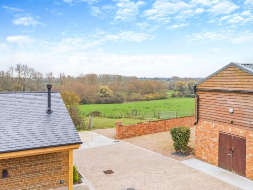 a house with a garage and a brick building at Hollyhocks - Uk47975 in Woodford