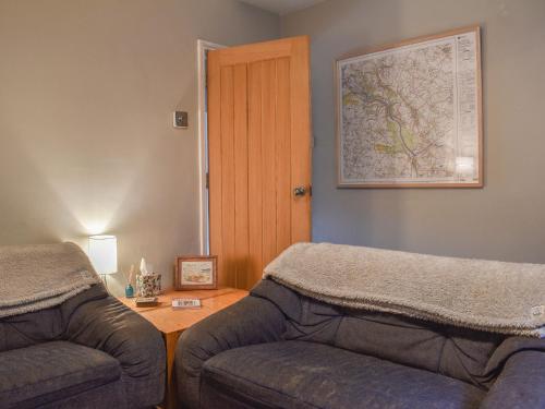 a living room with a couch and a table at Vine Cottages in Crich