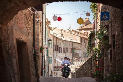 a person riding a motorcycle down an alley at Villa Fiorenzani in Radicondoli