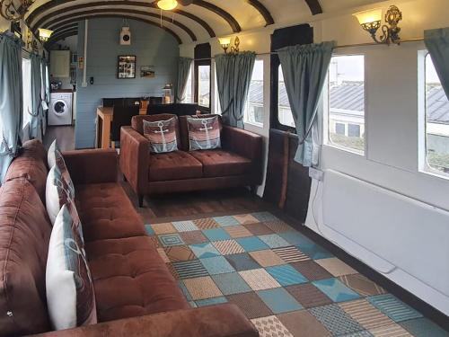 a living room with a couch and a table at Elsie in Blue Anchor