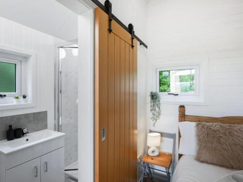 a bedroom with a bed and a sink and a mirror at Mini Lodge - Uk47682 in Montgomery