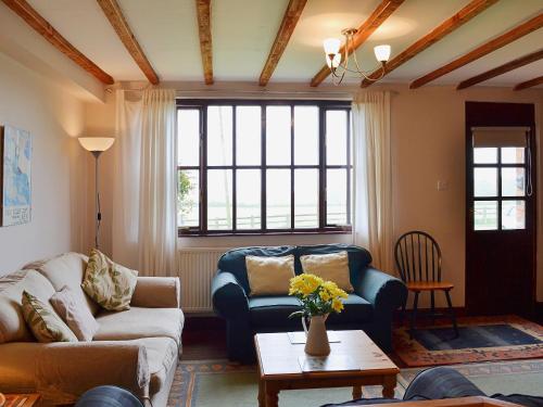 a living room with a couch and a table at Meadowsweet Cottage - E1496 in Scalby