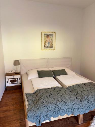 a bedroom with a large white bed and a table at Landhaus nähe Neusiedler See in Jois
