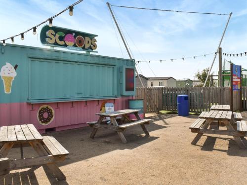 two picnic tables in front of a ice cream restaurant at The Moon in Heysham