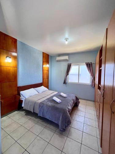 a bedroom with a bed with two towels on it at Pousada Village in Florianópolis