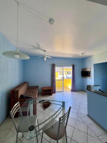 a living room with a glass table and chairs at Pousada Village in Florianópolis