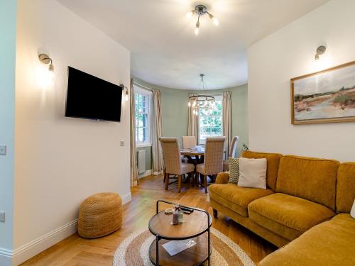 a living room with a couch and a table at West Lodge in Perth